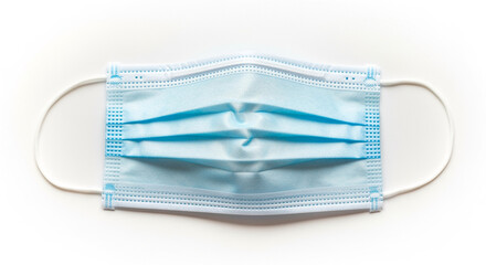 A blue surgical face mask on a white background for health protection