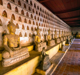 Partially destroyed ancient Budha figures in the historical Wat Si Saket Buddhist temple, Vientiane, Laos.