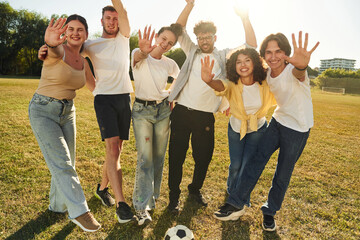Standing and posing. Group of friends are playing soccer on the field
