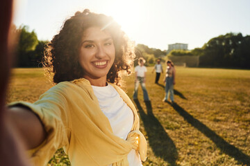 Modern style, selfie time. Young friends are having fun on the field