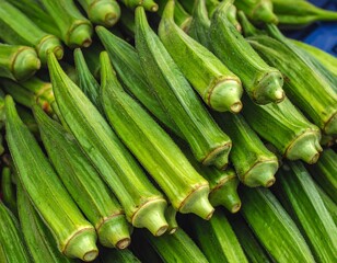 Obraz premium A close-up view presents a pile of fresh okra. Their vibrant green hues and angular shapes form a textured composition