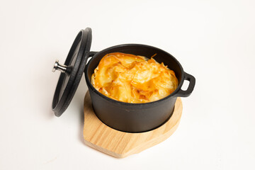 Close-up of baked dish in cast iron skillet - appetizing meal on white background