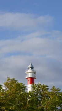The lighthouse, El Ropido village in Huelva province. Blue sky and white clouds. Holiday paradise. 4K at 50 fps. Vertical