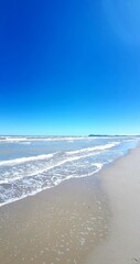Beach and blue sky with white clouds. Seascape.