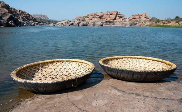Coracle boats at the Tungabhadra River in Hampi, India, traditional round fishing basket boat made from cane, leather and bitumen