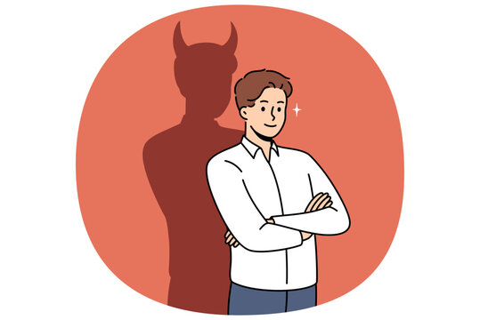 Confident businessman with bad thoughts stands with arms crossed near shadow with devil horns. Bad male office worker with treacherous ideas, wants to achieve goal in unethical way