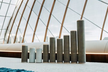 Futuristic cylindrical display showcasing data progression, growth, and innovative design in a modern architectural setting