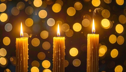 Row of Lit Yellow Candles with Golden Bokeh Lights Creating Festive and Cozy Atmosphere