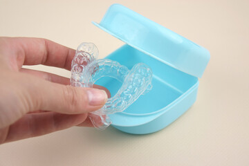 The transparent mouth guards for teeth at night after wearing braces.