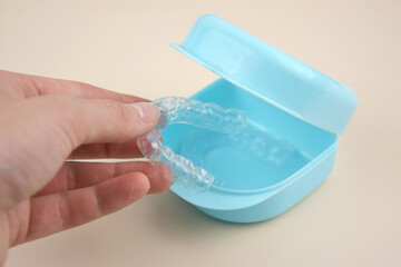 The transparent mouth guards for teeth at night after wearing braces.