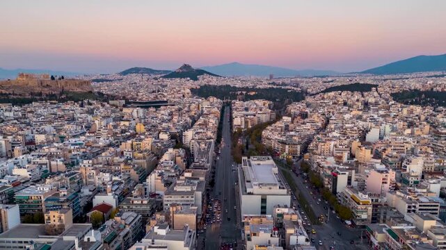 Aerial hyperlapse view of the Syggrou Street leading from the Palio Faliro district into the City of Athens, Greece, during sunset to dusk