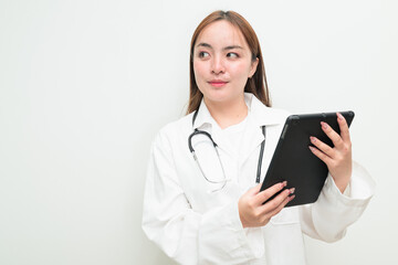 Portrait of young Asian female doctor against white background using tablet computer