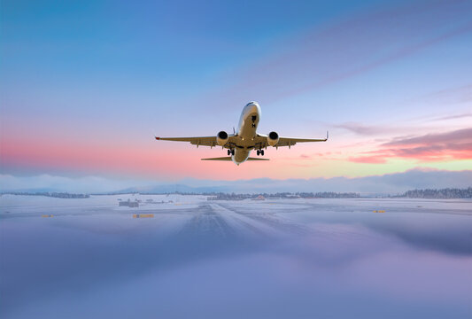 A passenger plane taking off from a foggy and icy runway - Norway