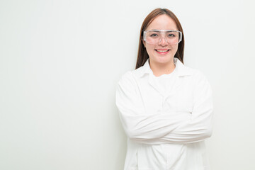 Portrait of Asian female research scientist against white background with arms crossed smiling