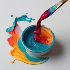 Paintbrush mixing vibrant colors in a pot