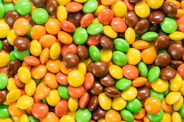 Top view of colorful candy coated chocolates background.