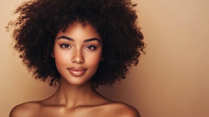 Beauty portrait of African American woman with clean healthy skin on beige background, smiling dreamy beautiful black woman, curly afro hair