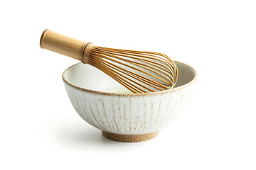 Matcha whisk in a ceramic bowl on white background