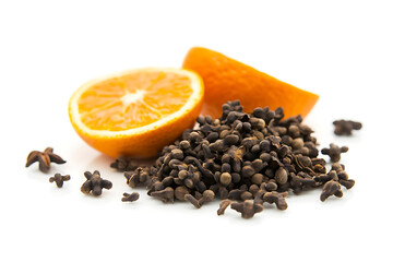 Fresh orange slices with aromatic whole cloves on white background