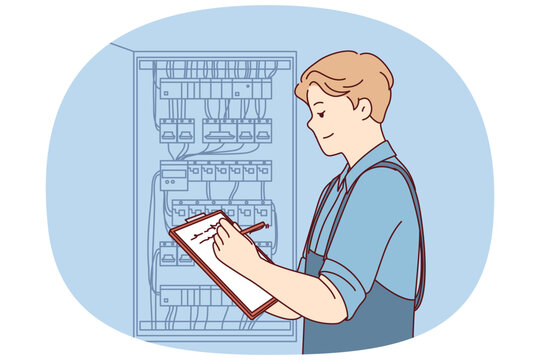 Man inspector checks electrical equipment installed in metal power panel, makes notes in clipboard. Electrician guy stands near power panel, drawing up work plan for replacing wires.