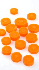 Vibrant Carrot Slices on White Background - A Culinary Delight.