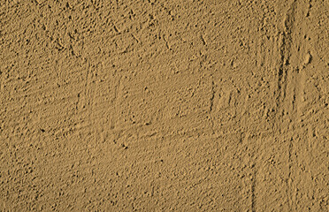 Warm yellow textured plaster wall background.