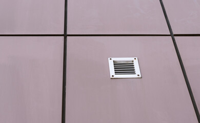 Minimalist industrial wall panels with ventilation grille.