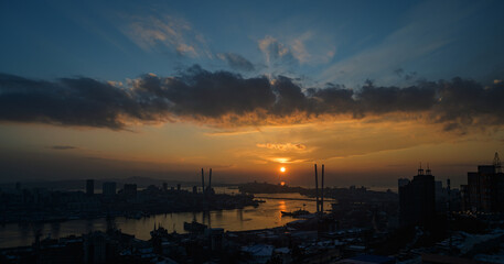 Dramatic sunset over the Golden Horn bay: a battle of golden light and clouds.