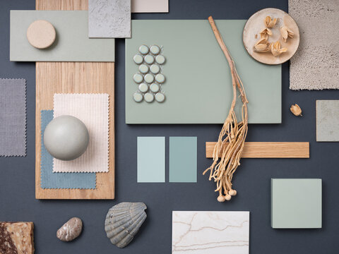 Elegant  flat lay composition in green, blue and beige color palette with textile and paint samples, lamella panels and tiles. Architect and interior designer moodboard. Top view. Copy space.