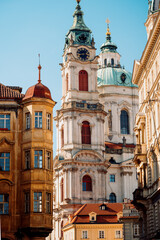 Grand Golden Facade With Clock, Sunlit Narrow Street Focuses On Towering Historic Elegance And Charm © Val MAK