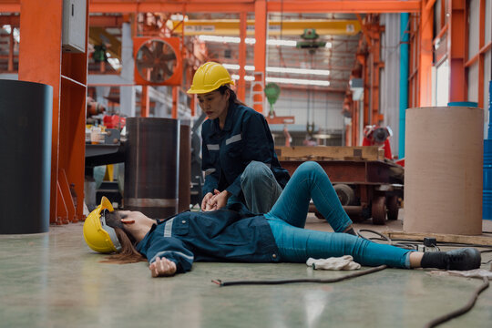 A female officer is checking her friend's pulse after an electrical shock accident.