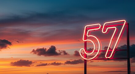 Vibrant neon sign displaying the number 57 against a dramatic sunset sky with clouds