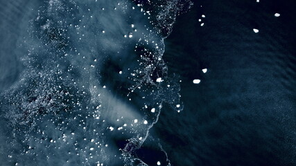 Aerial view of icy waterscapes where glaciers meet the sea, dotted with floating ice, creating a mesmerizing dance of light and shadow, Blackstone Bay, Alaska, United States.