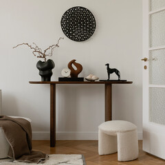 Elegant console table styling with artistic sculptures, ceramics, and decorative elements. A...