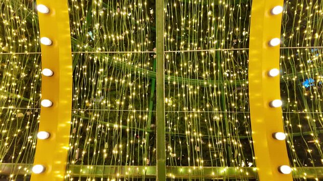 Camera video of golden holiday lights glowing in rows
