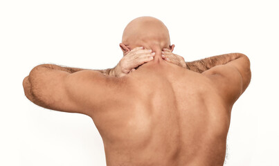 Man suffering from neck pain, hands behind head. Neck pain in naked bald man. White background.