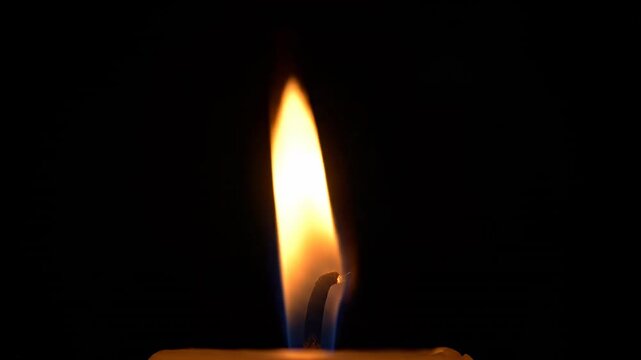 Isolated single candle flame flickering gently and stably on a solid black background ready for easy compositing and keying intensity, alpha, luminous