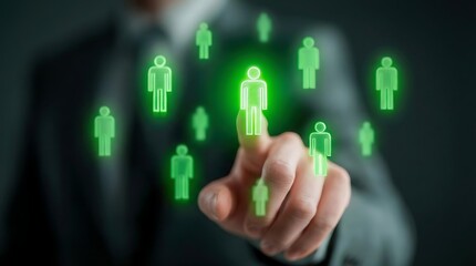 Businessman selecting bright green human profile icon on transparent digital interface for recruitment and global networking