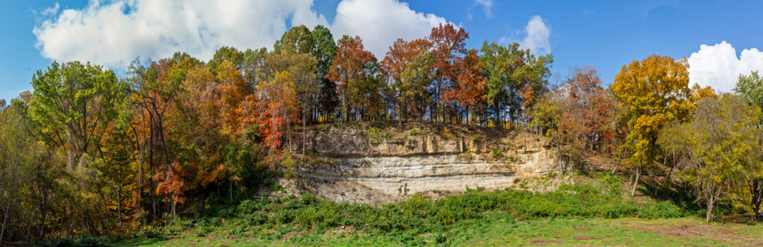 Panoramic landscape of a bluff topped with colorful Autumn trees along Highway 94 in St. Charles County near Augusta, Missouri