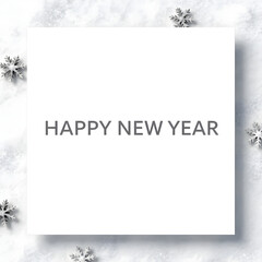 White card with happy new year message on snow