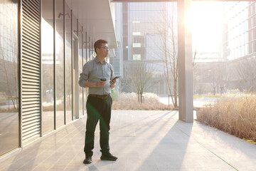 asian businessman using smart phone outdoor