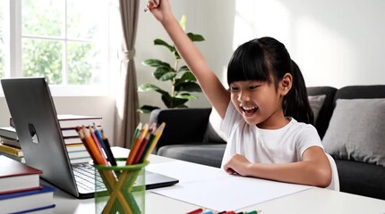 Happy Asian Schoolgirl Raising Hand Enthusiastically During Online Learning Class at Home, Engaged in Remote Education with Laptop and Art Supplies