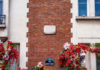 Marble commemorative plaque to Gaston Couté, poet and singer, known for his pacifist and anarchist texts, in Place du Tertre, butte of Montmartre, Paris, France