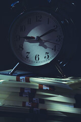 Night scene with clock and cash stacks, representing time management, late work, financial ambition, urgency, responsibility, and economic pressure.