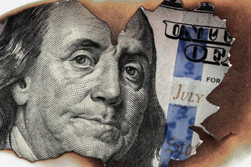 Burning US Dollar bill as a symbol of global inflation and the financial crisis