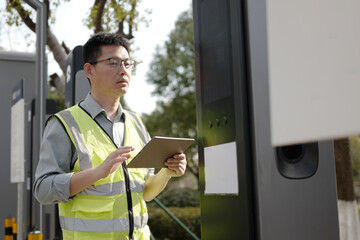 asian Worker uses tablet at charging station