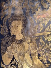 Intricate Golden Artwork of a Traditional Thai Dancer with Colorful Background