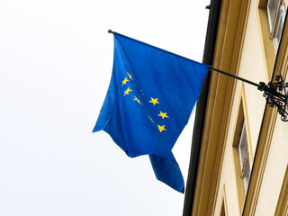 European union flag waving on building against clear sky