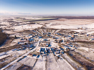 Aerial view of Charlottenburg, the only circular village in Romania, covered in winter snow