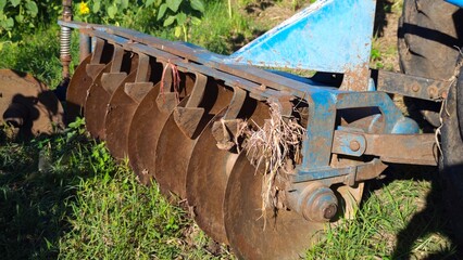 Steel plowing disks on a farming tractor.